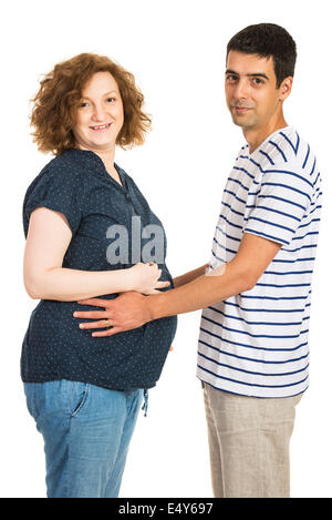 Happy couple standing face to face and holding their hands on pregnant tummy isolated on white background Stock Photo