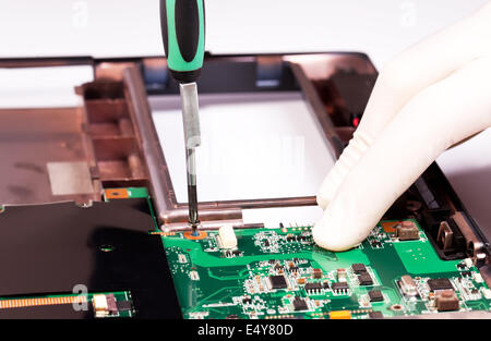 Laptop mother board fixing Stock Photo