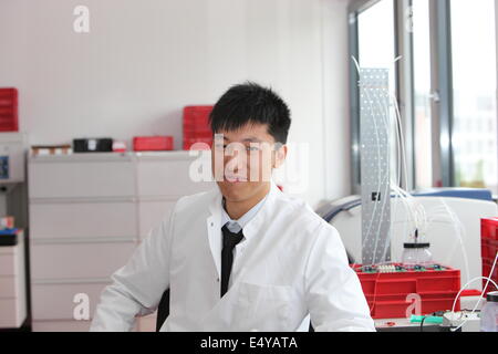 Asian technician working in a laboratory Stock Photo