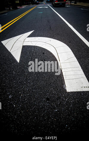 painted direction arrow on pavement Stock Photo