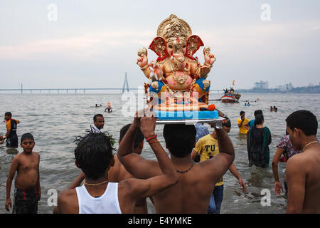 Immersing Lord Ganesh at Ganesh Chaturthi festival celebrations on Girgaum Chowpatty beach in Mumbai, India in 2013 Stock Photo