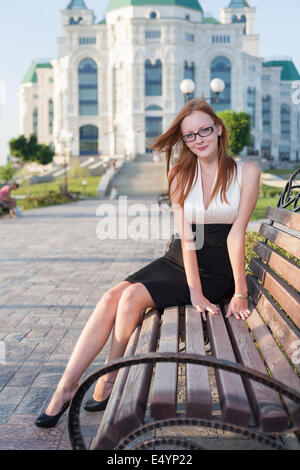 pretty teen girl sitting on the bench Stock Photo