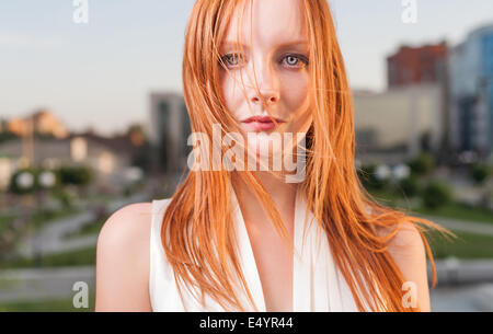 Portrait of freckled young woman cityscape
