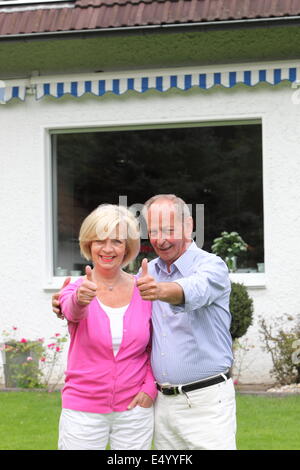 Senior couple giving a thumbs up gesture Stock Photo