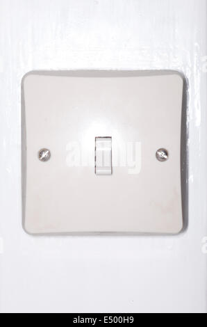 White plastic bakelite light switch switched on. Stock Photo