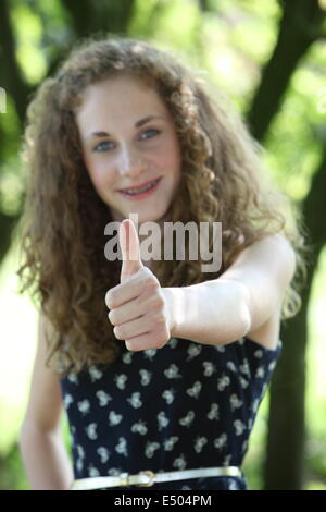 Happy teenage girl giving a thumbs up Stock Photo