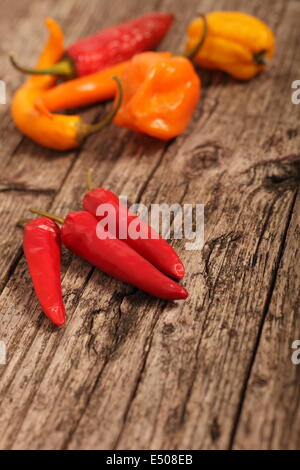 Chilli peppers on a wooden surface Stock Photo