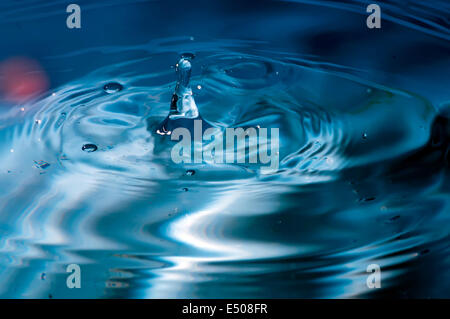 blue multi colored water drop bubbling Stock Photo