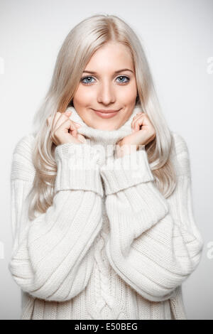 Blonde woman in cashmere sweater Stock Photo