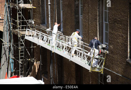 men in cradle painting the exterior of Lowthian House 1960 s brutalist ...