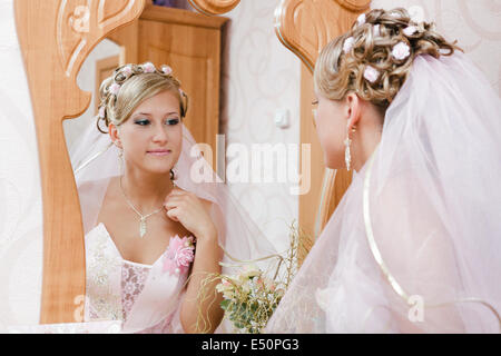 bride looks in the mirror Stock Photo