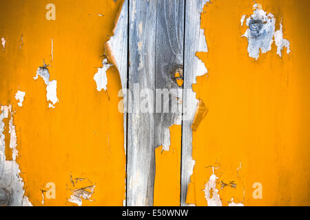 mottled wooden door with peeling paint Stock Photo