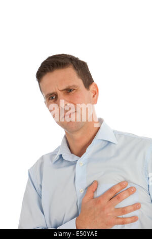 Man clutching his chest with his hand Stock Photo