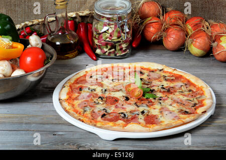 The Italian pizza with a ham and mushrooms Stock Photo