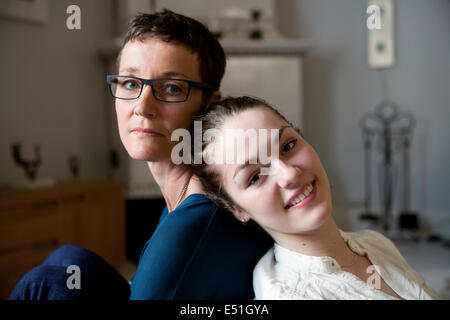 Portrait of mother with daughter (16-17) back to back Stock Photo