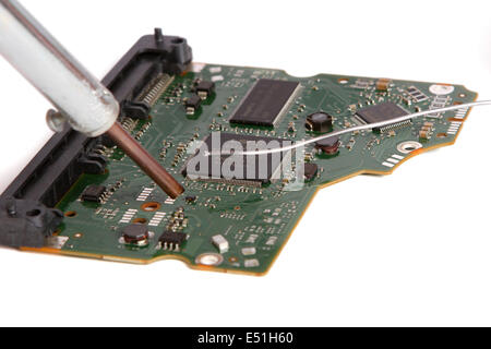soldering iron in his hand on a white Stock Photo