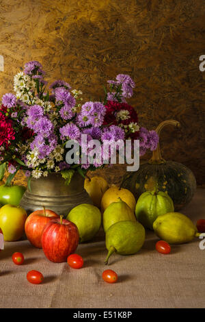 Still life with Fruits were placed together with a vase of flowers beautifully. Stock Photo