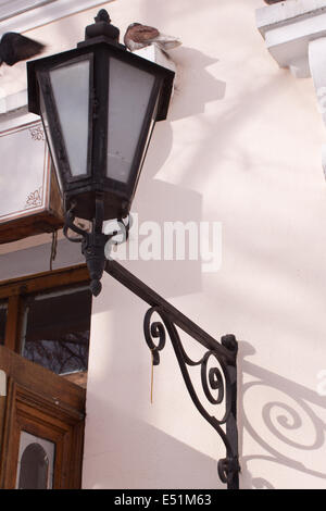 wrought iron lamp on a weathered wall Stock Photo