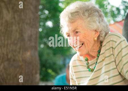 Senior woman smiling outdoors Stock Photo