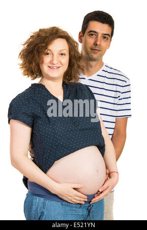 Expectant couple standing in embrace isolated on white background Stock Photo