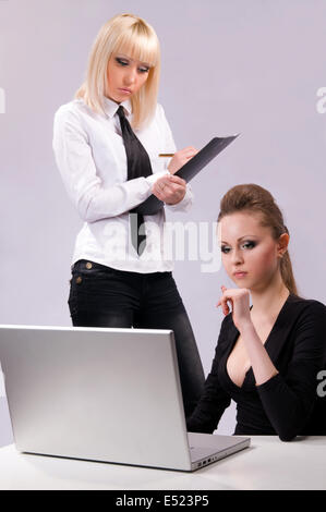 Two women working on a laptop Stock Photo