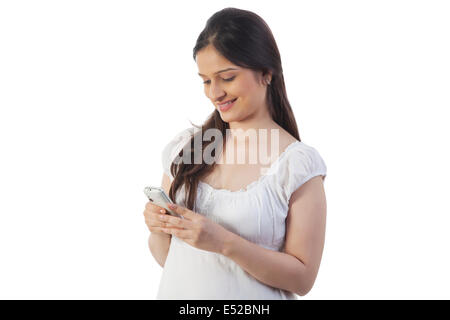 Pregnant woman using her mobile phone Stock Photo