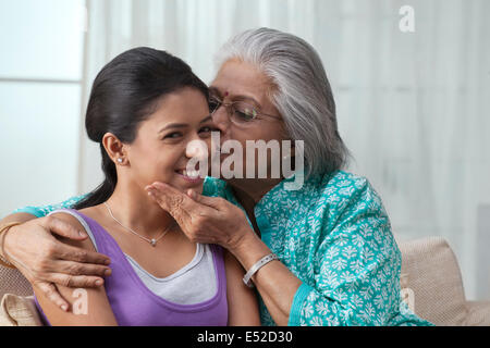 Grandmother kissing her granddaughter Stock Photo