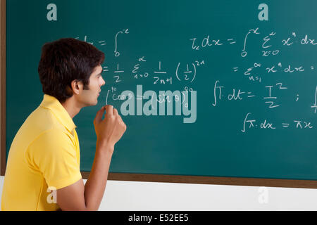 College student trying to solve a maths equation Stock Photo - Alamy