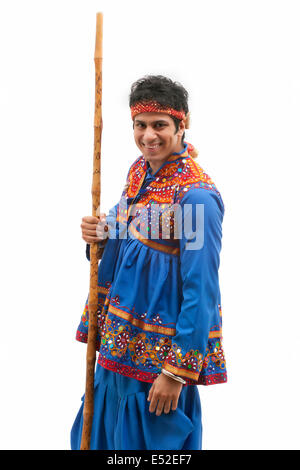 Portrait of happy man in kedia and dhoti performing Dandiya Rass Stock ...