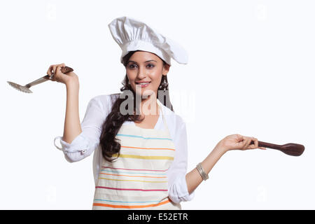 Female chef with cooking utensils Stock Photo