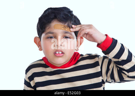 Portrait of little boy with band-aid on forehead Stock Photo