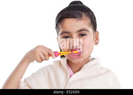 Portrait of little girl brushing her teeth Stock Photo