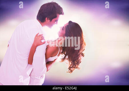 Loving young couple dancing over colored background Stock Photo