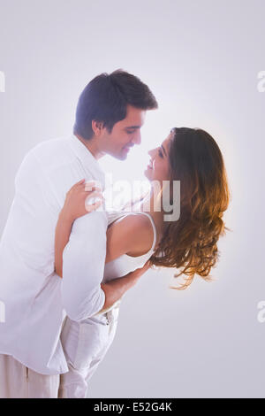 Loving young couple dancing over white background Stock Photo