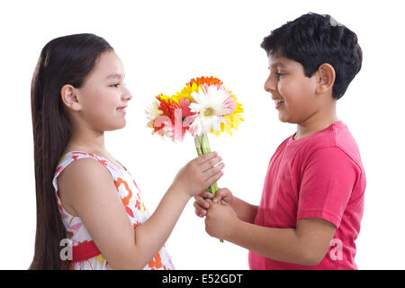 Boy giving flowers to a girl Stock Photo