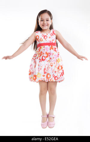Portrait of little girl jumping in the air Stock Photo