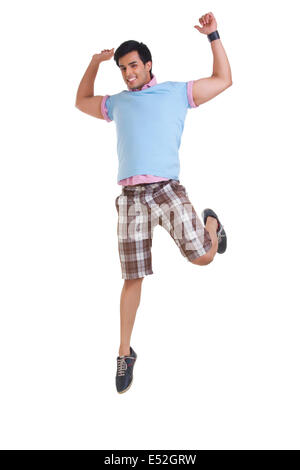 Full length of young man in casuals jumping isolated over white background Stock Photo