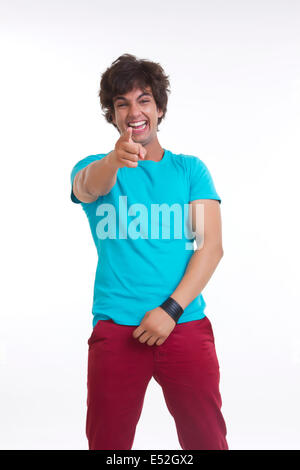 Full length portrait of cheerful young man pointing at you over white background Stock Photo