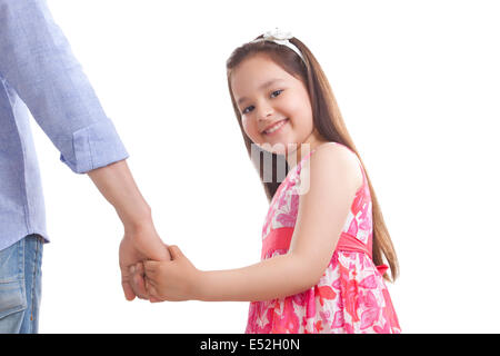 Portrait of little girl holding father's hand against white background Stock Photo