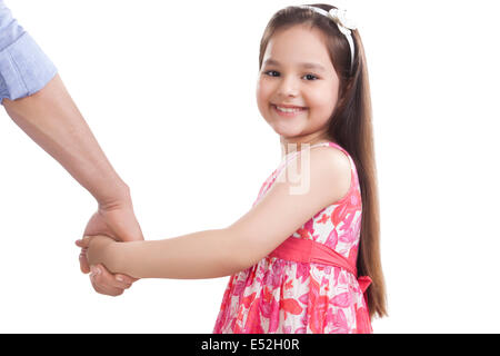 Portrait of cute girl holding father's hand against white background Stock Photo