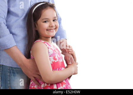 Portrait of girl holding father's hand against white background Stock Photo