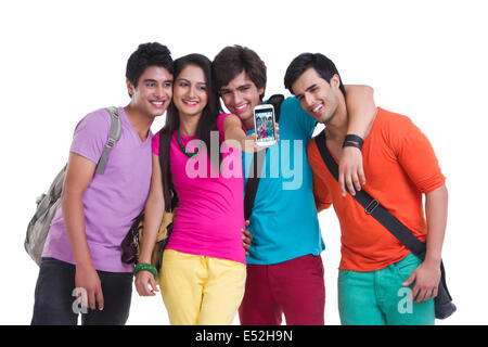 Happy university friends taking picture of themselves over white background Stock Photo