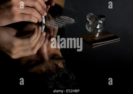 Man snorting cocaine through rolled up dollar bill Stock Photo ...