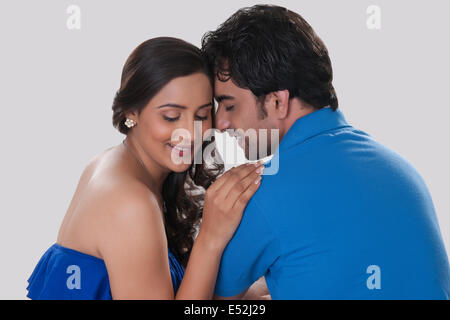 Affectionate young couple over white background Stock Photo