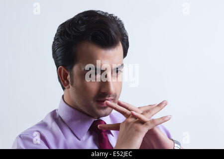 Thoughtful young businessman over white background Stock Photo