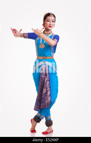 Full length portrait of beautiful woman performing Bharatanatyam on white background Stock Photo
