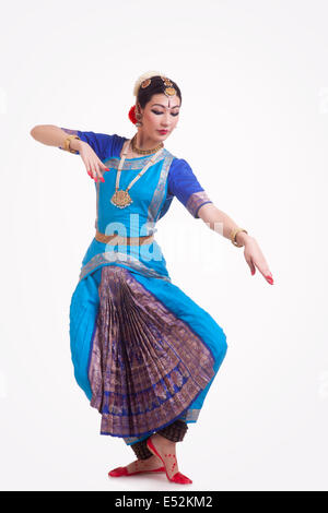 Full length of beautiful woman performing Indian Bharat Natyam dance on white background Stock Photo