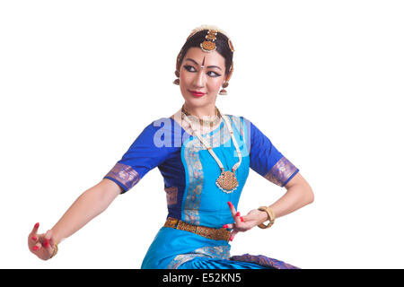 Beautiful Bharat Natyam dancer performing over white background Stock Photo