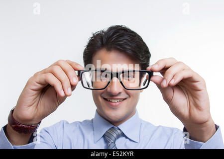 Businessman looking through spectacles Stock Photo