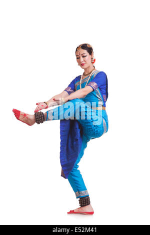 Full length of woman performing Bharatanatyam against white background Stock Photo